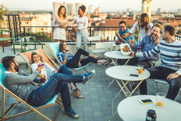 istock Large group of happy business people having fun on a balcony after work. 1057836442