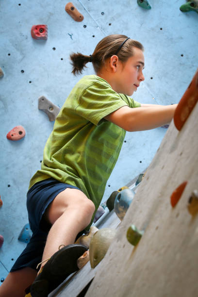 istock Teenage Boy Training Climbing On Indoor Climbing Wall 1057838224