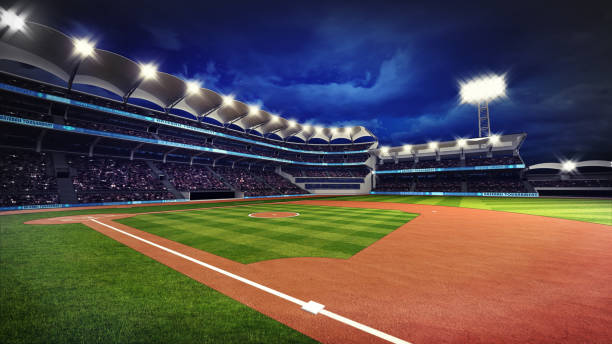 istock illuminated baseball stadium with spectators and green grass 1057839352