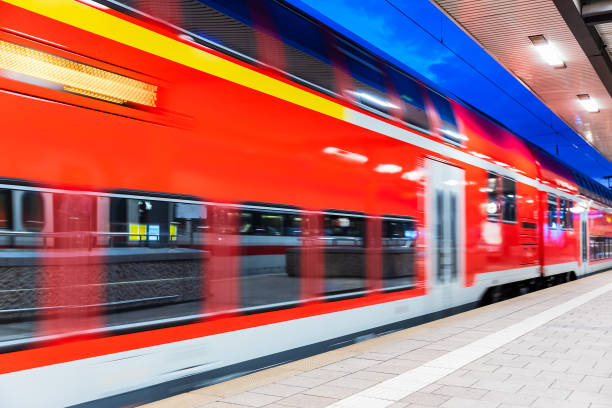 istock High speed train at railway station platform at night 1057843418