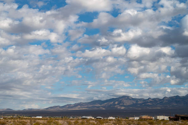 istock Mojave desert valley, mountain range, cloudy skies 1057853402