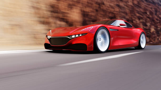 istock red car driving on a road by sea 1057853434