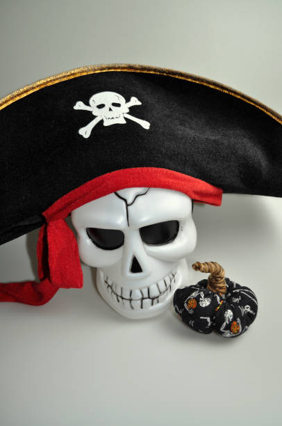 istock halloween - cute skull with decorative pumpkin 1057853682