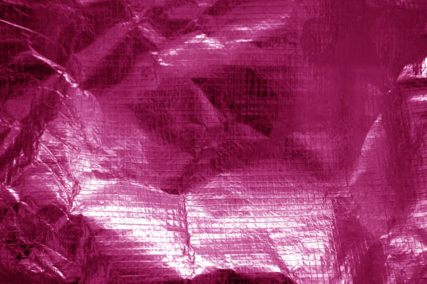 istock Crumpled plastic textile texture in pink color. 1057862044