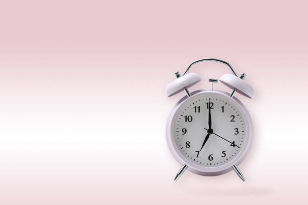 istock retro alarm clock on pink background, pastel pink alarm clock with clipping path 1057862612