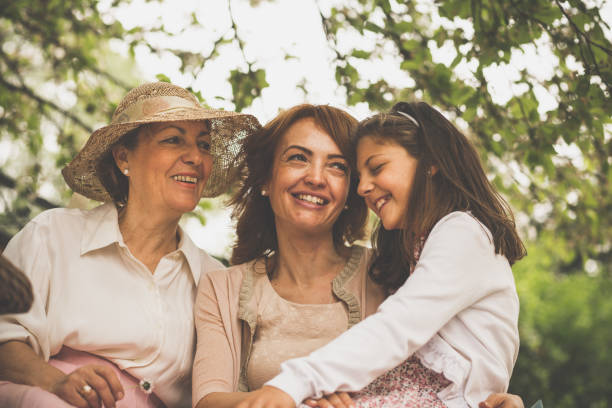 istock Happy women relaxing under treetop 1057864100