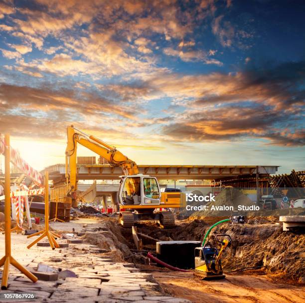 Excavator On A Road Construction Site Stock Photo - Download Image Now - Construction Site, Construction Industry, Road