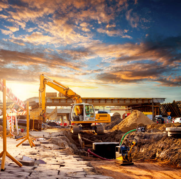 excavator on a road construction site - industrial equipment trackhoe construction site construction vehicle imagens e fotografias de stock