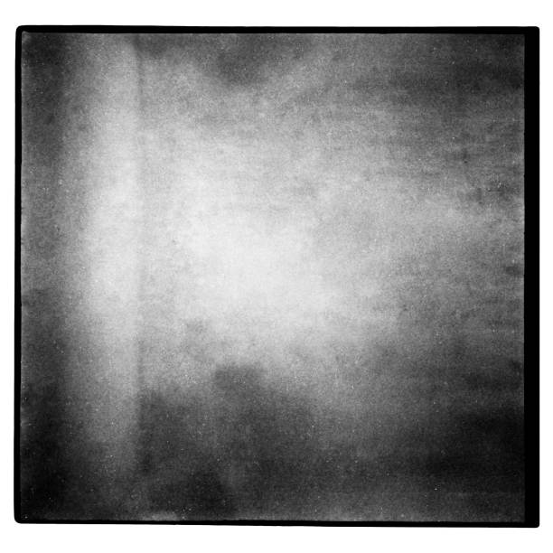 istock Black and white medium format film background with grain and light leak. 1057868902