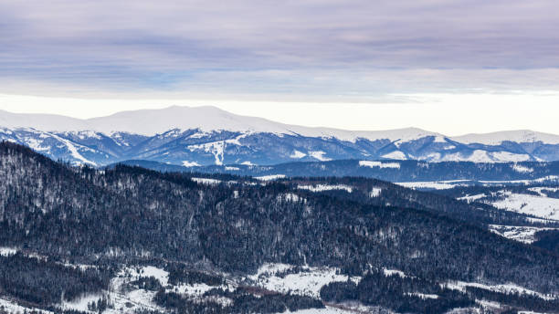 istock Mountain peak with snow blow by wind. Winter landscape. Cold day, with snow. 1057872714