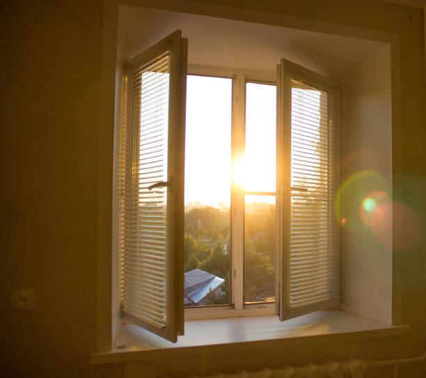 istock sun rise behind the window blinds and curtains shades 1057876870