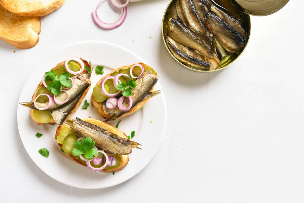 istock Sandwiches with sprats, marinated cucumber and onion 1057881490