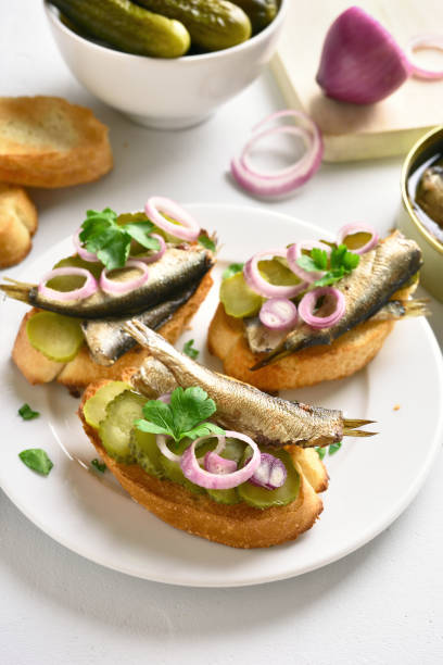 istock Sandwiches with sprats, marinated cucumber and onion 1057881532