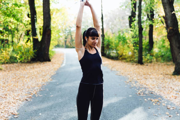 istock Fit young woman stretching in forest 1057885934