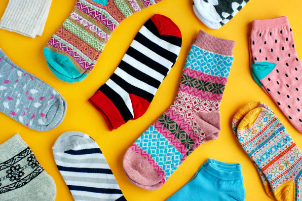 istock Multi-colored socks on a yellow background. View from above. 1057888706