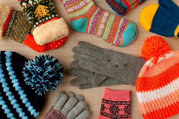istock Different warm clothes scattered on the table. View from above. 1057888722