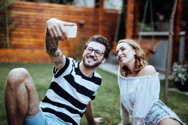 istock Young couple taking selfie in the park 1057890348