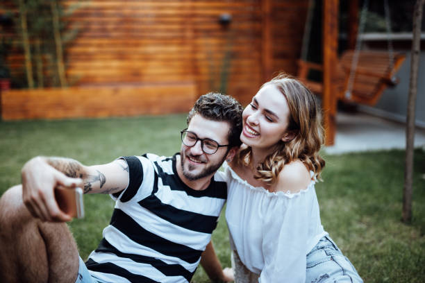 istock Young couple taking selfie in the park 1057890350