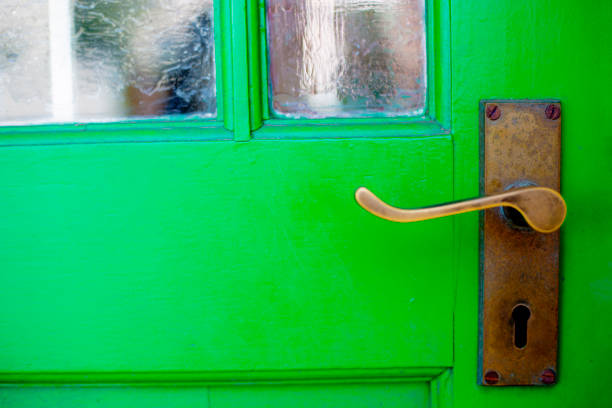 istock Closed  green door with brass handle 1057892500