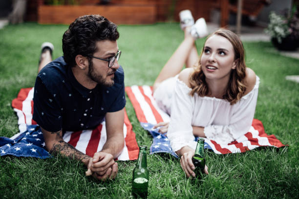 istock Young couple laying on the grass in a park 1057892614