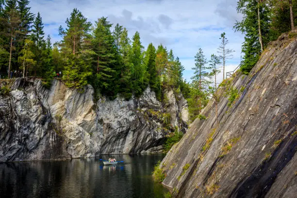 Photo of Marble quarry Ruskeala. Invalid marble quarry. Sights of Karelia in Russia. Quarry marble. Pieces of marble.