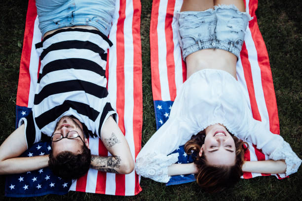 istock Young couple laying in grass and daydreaming 1057897910