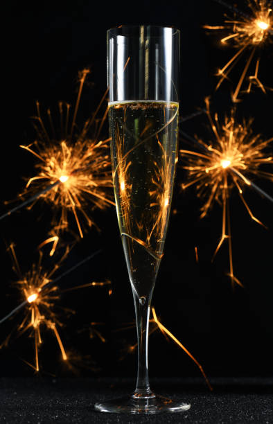 istock glass with champagne and sparkles 1057902248