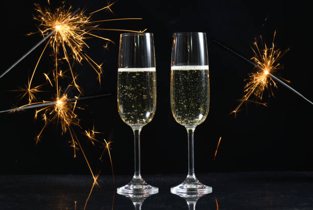 istock glasses with champagne and sparkles 1057902308