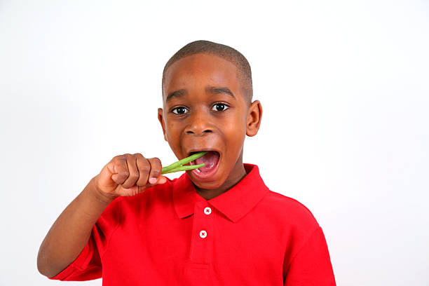 African American Boy Eating Green Beans stock photo