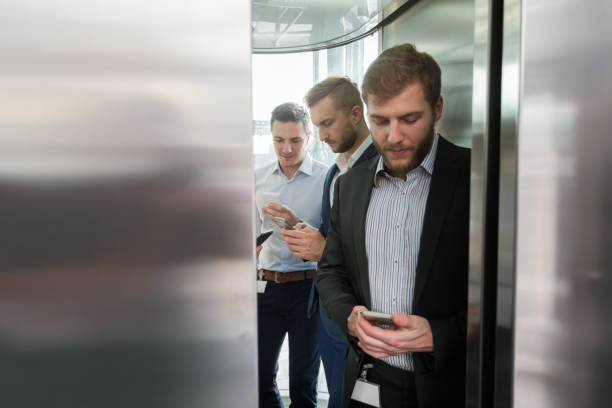 istock Businessmen behind elevator door closing 1057912458