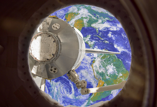 Earth in spaceship international space station window porthole. Elements of this image furnished by NASA.