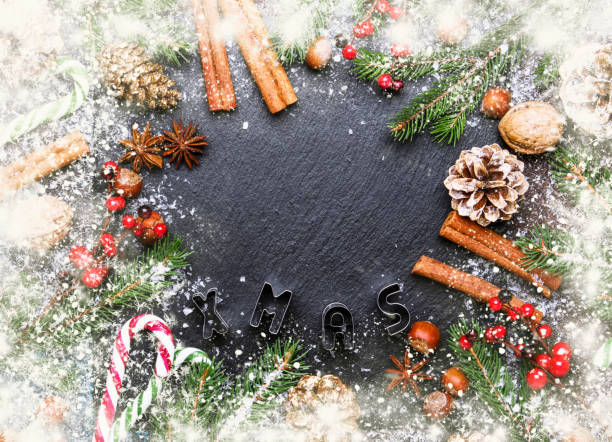 istock Christmas or New Year dark background, frame, template, with festive decorations, winter spices and Christmas decorations 1057913636