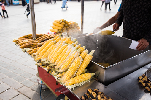 Fresh boiled and roasted corn is famous street food of Istanbul, Turkey. Grilled corn on the hot stove