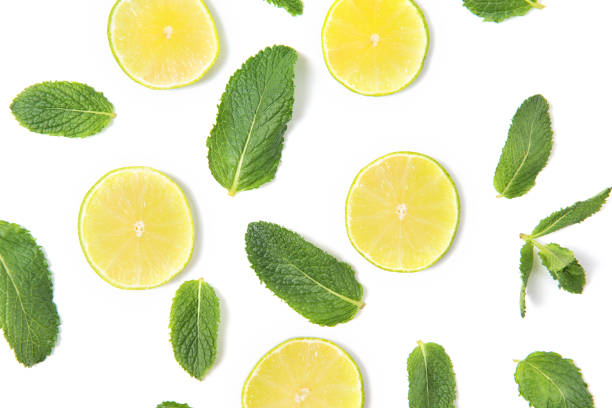 istock Ripe lime slices and mint leaves pattern isolated on white background, top view 1057915184