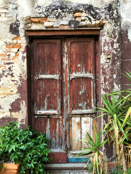 istock Old brick wall with wooden door, grunge background texture 1057916968