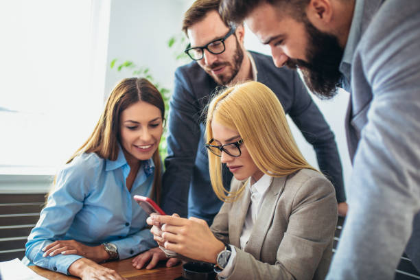 istock Business people working together on project and brainstorming in office using smart phone. 1057919070