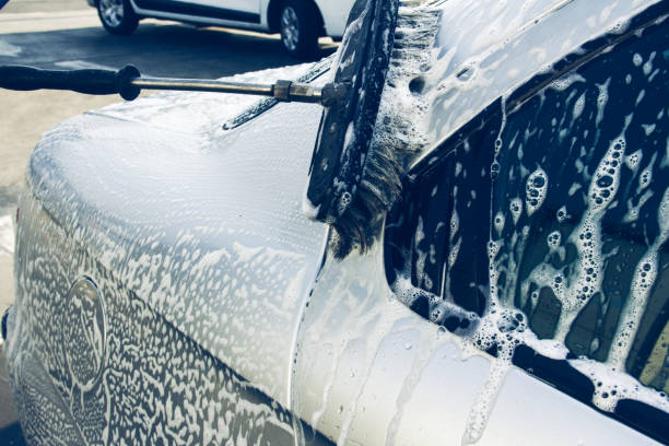 istock Washing car using brushes with foam on a car wash 1057921328