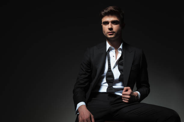 istock portrait of confident groom looking up to side while sitting 1057921348