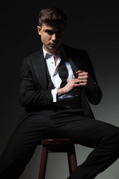 istock portrait of handsome groom pulling something from pocket 1057921384
