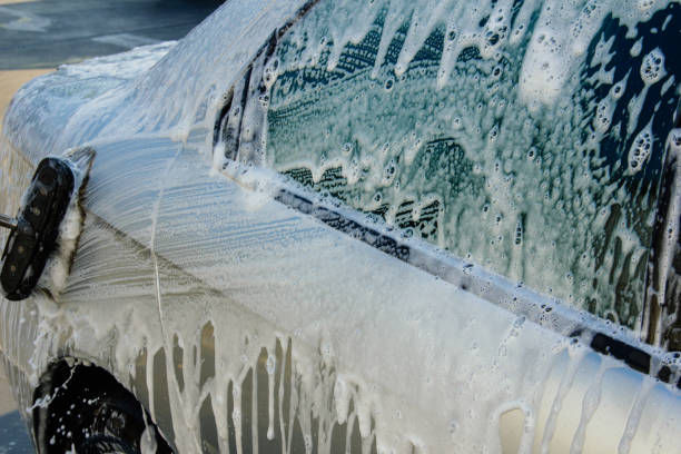 istock Washing car using brushes with foam on a car wash 1057921390