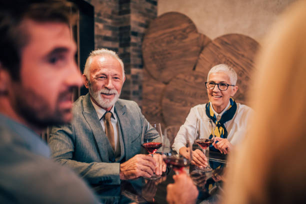 istock Young man drinking wine with family 1057924414