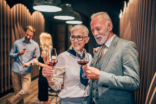 Happy couple having wine tasting at winery