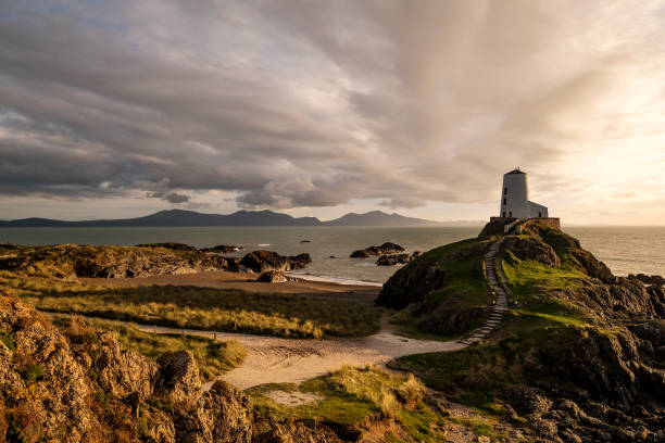 Llanddwyn Island, Anglesey, Wales with Obsolete Lighthouse Obsolete lighthouse on this island of myth and legend. Image recorded at sunset. snowdonia national park photos stock pictures, royalty-free photos & images
