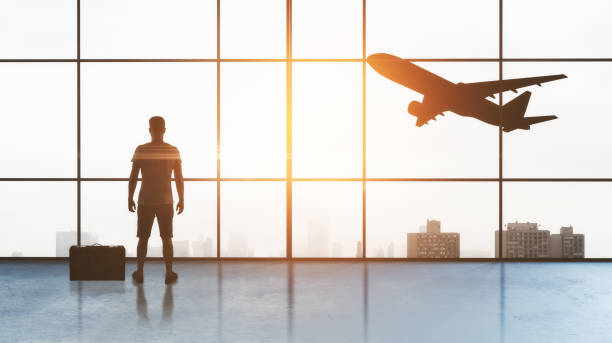 istock man in airport and plane 1057926472