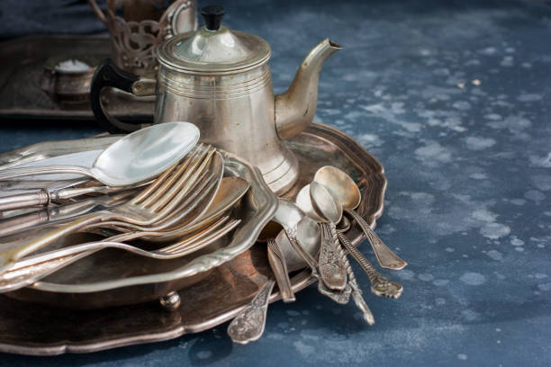 istock Vintage old utensils made of nickel silver, tableware (kettle, teaspoons, tablespoons, knives, forks, tray, dish), horizontal, space for text 1057928864