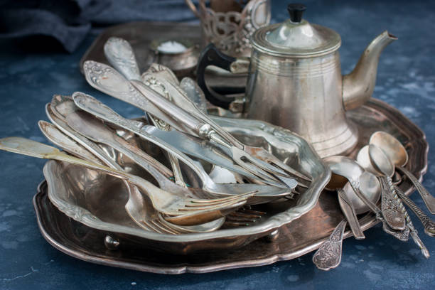 istock Vintage old utensils made of nickel silver, tableware (kettle, teaspoons, tablespoons, knives, forks, tray, dish), horizontal, space for text 1057928866