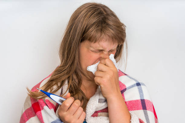 Sick woman with flu or cold sneezing into handkerchief Sick woman with flu or cold sneezing into handkerchief - cold and flu concept Tickly Cough stock pictures, royalty-free photos & images