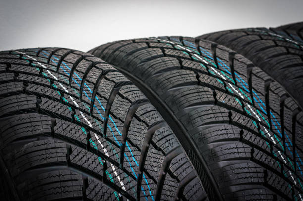 istock Winter car tires in row isolated on gray 1057929338