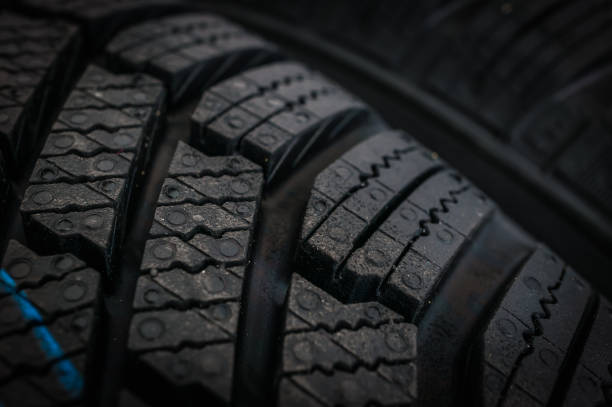 istock Winter car tires in row isolated on black 1057929488