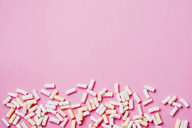 istock Marshmallows on pink background with copyspace. Flat lay. Background or texture of colorful mini marshmallows. 1057929556